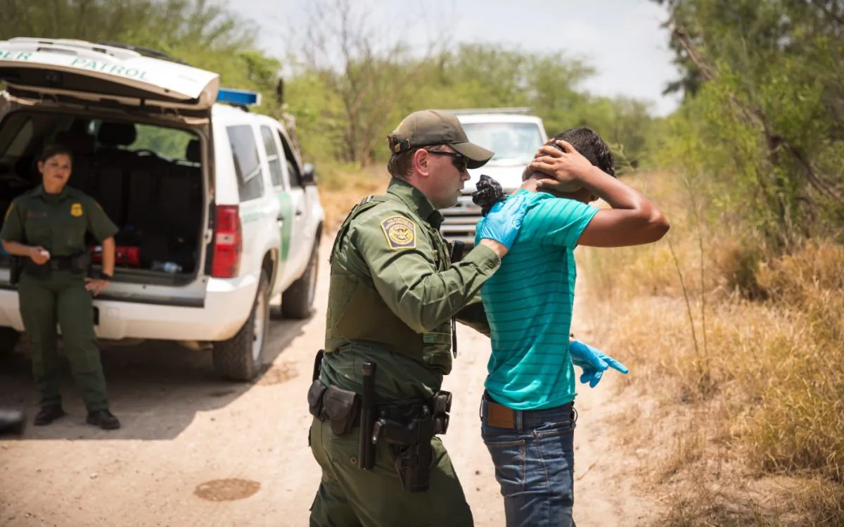 File photo showing a U.S. Border Patrol agent patting down a man who crossed the Rio Grande illegally, in Hidalgo County, Texas, May 26, 2017. (Benjamin Chasteen/The Epoch Times)
