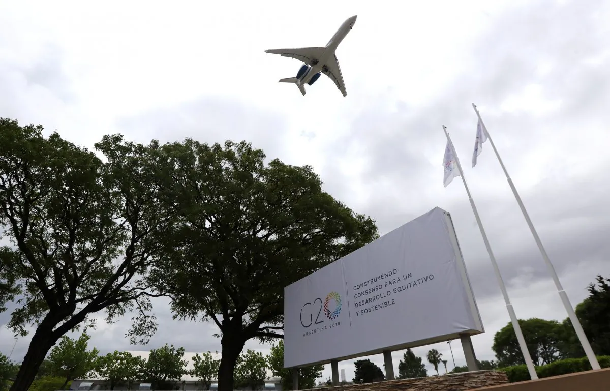 A plane flies over a G20 Summit banner at the Summit's International Media Center in Buenos Aires, Argentina November 29, 2018. (Marcos Brindicci/Reuters)