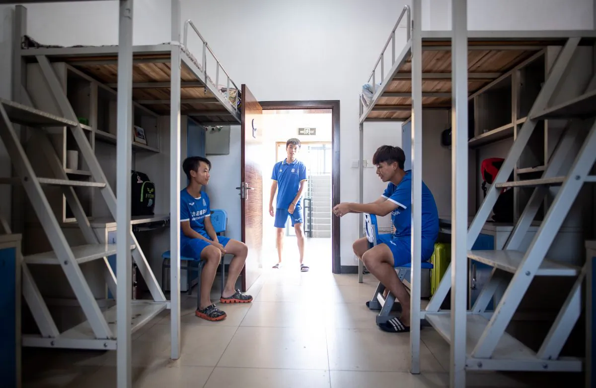 This picture taken on September 21, 2018 shows students in their dormitory after a training session at the Guangzhou Football Academy in Meizhou in southern China's Guangdong province. (JOHANNES EISELE/AFP/Getty Images)