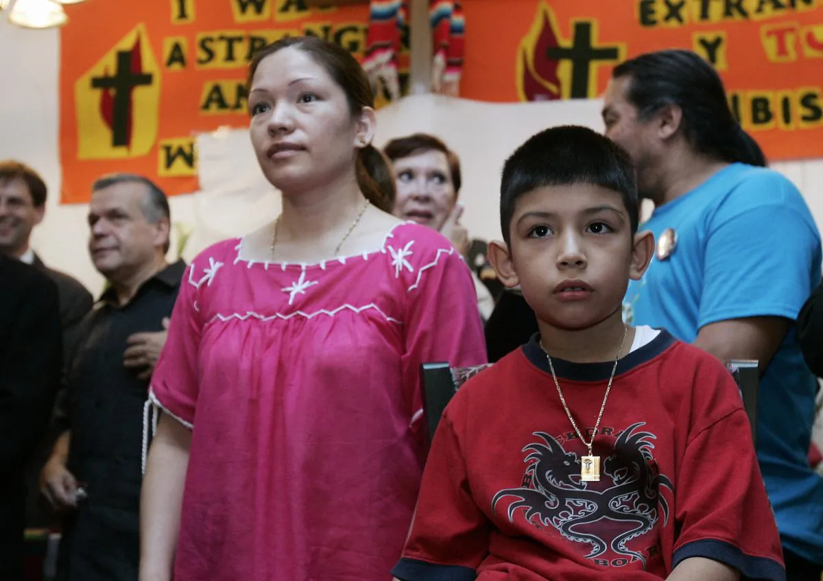 Immigrant rights activist Elvira Arellano (L) of Mexico stands with her U.S.-born son Saul at a press conference inside the Adalberto United Methodist Church on Aug. 15, 2007, in Chicago, Illinois, where she had taken refuge for a year because she faced deportation. She became the poster child for those who argue that illegal aliens with U.S.-born children should never face deportation. (JEFF HAYNES/AFP/Getty Images)