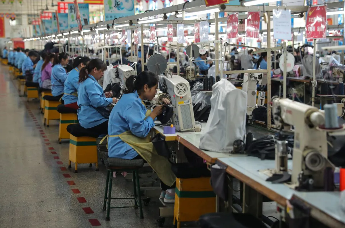 Workers sew shoes at a factory in Qingdao, Shandong Province, China. (STR/AFP/Getty Images)