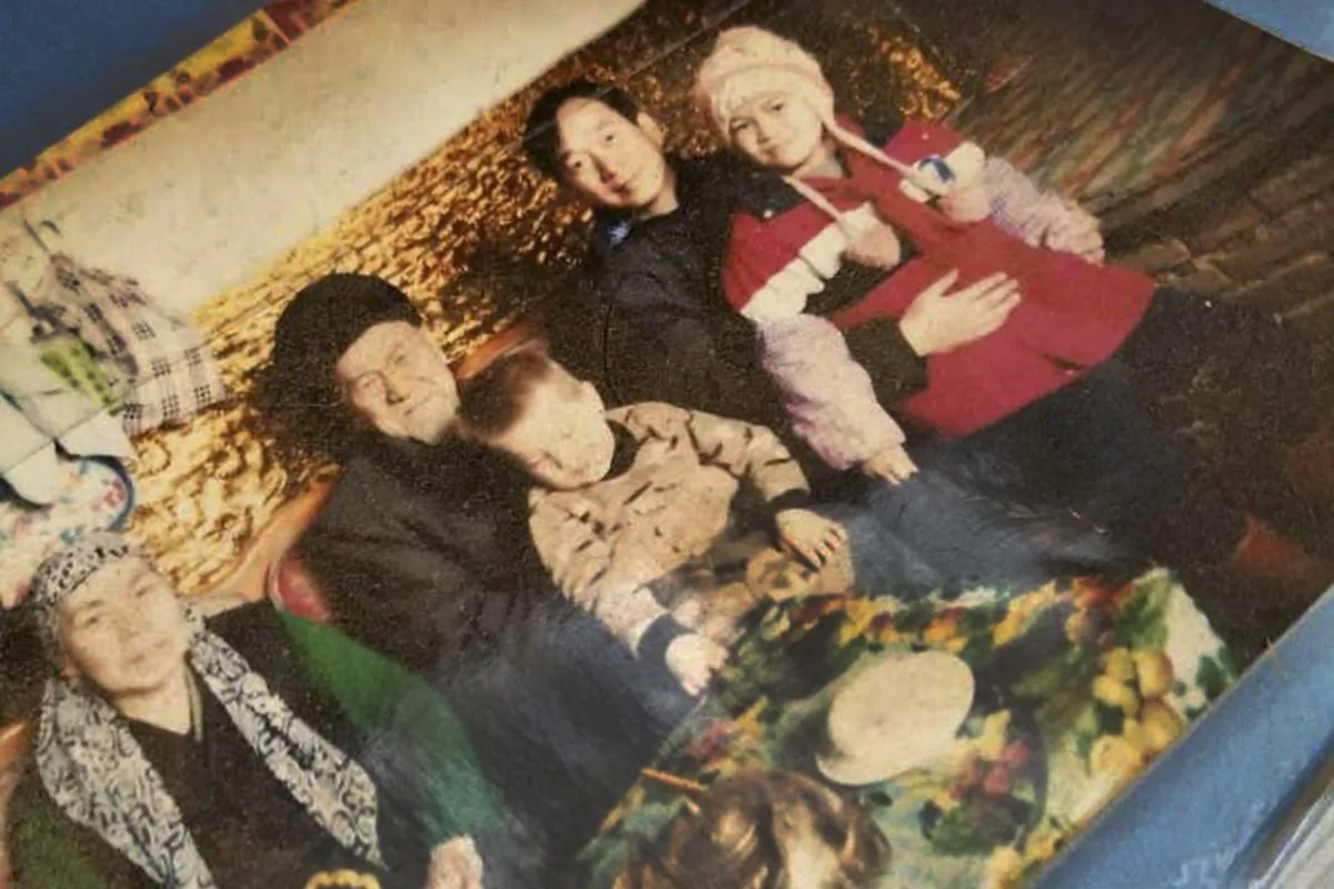 This undated photo provided by Ablikim Abliz, shows his uncle's family posing with an unknown Han Chinese man, second from the right, in Istanbul, Turkey. Abliz heard the Han Chinese man was part of a government homestay program meant to monitor his relatives, part of a broader crackdown on religious expression in China's far western region of Xinjiang. More than a million Chinese civil servants have been assigned to move into the homes of Uyghurs and other ethnic minorities, spending weeks as uninvited guests. While government notices about the "Pair Up and Become Family" program portray it as an affectionate cultural exchange, exiled Uyghurs living in Turkey said their loved ones saw the campaign as a chilling intrusion, aimed at coercing Uyghurs into living secular lives like the Han majority. (Ablikim Abliz via AP)