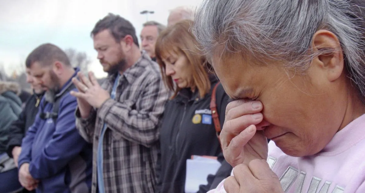 Venus Walker, of Warren, Ohio and a GM employee with 12 years at the Lordstown plant, prays during a vigil outside the Lordstown GM plant, on Nov. 29, 2018. (William D. Lewis/The Vindicator via AP) 