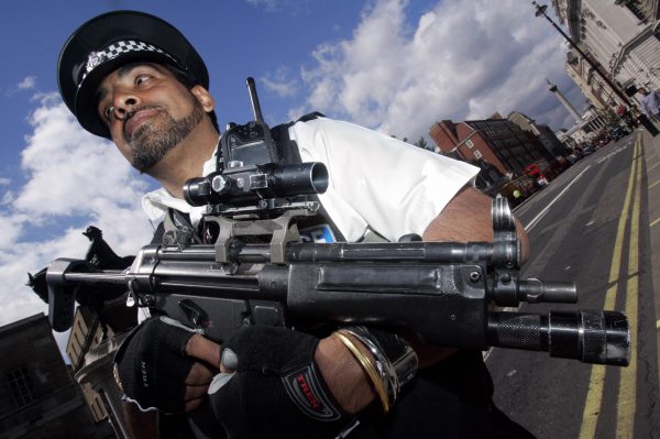 An armed response police officer stands guard on Whitehall, London