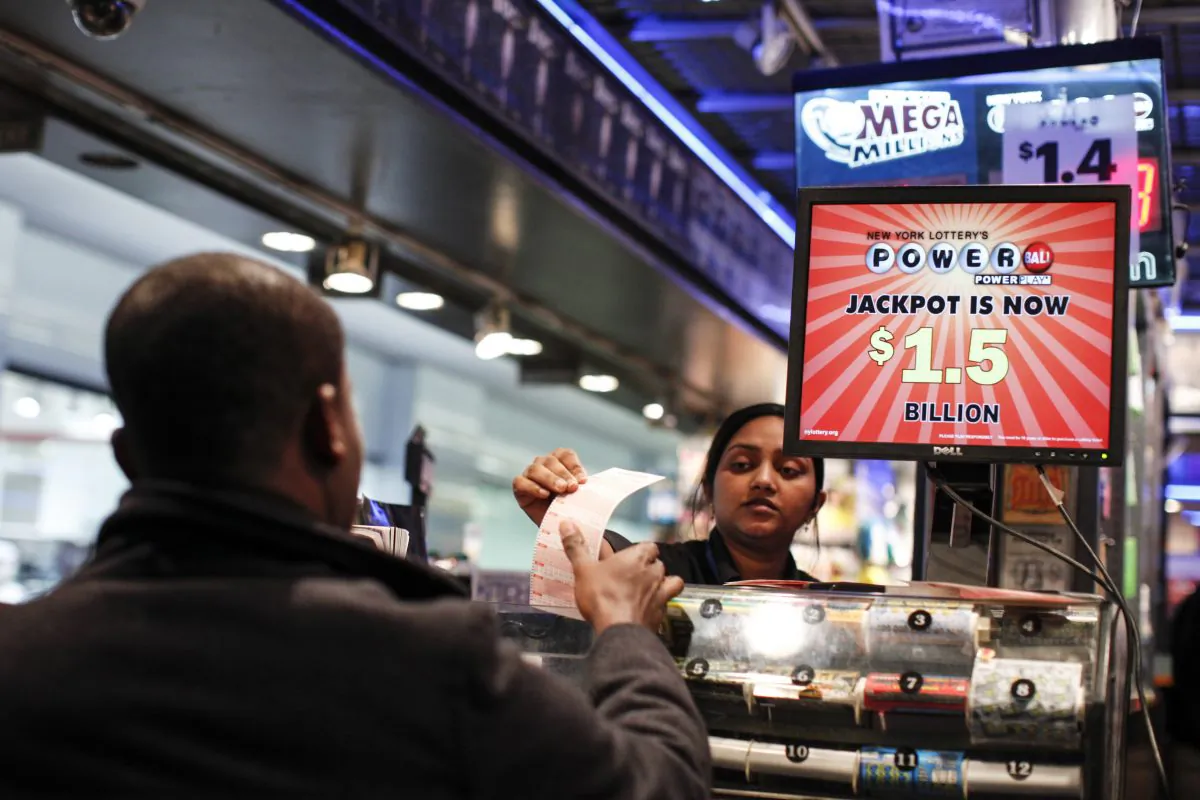 In this file photo a man buys a Powerball lottery ticket at a newsstand in New York City. Some people like state lotteries because they are run by the government; others are suspicious of them for that same reason. (KENA BETANCUR/AFP/Getty Images)