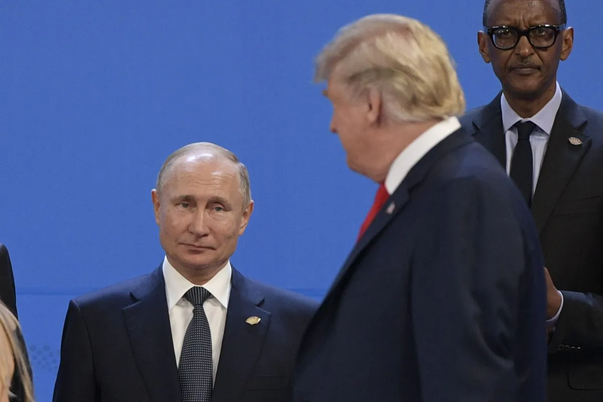 President Donald Trump (R), looks at Russia's President Vladimir Putin as they take place for a family photo, during the G20 Leaders' Summit in Buenos Aires, on Nov. 30, 2018. (Juan Mabromata/AFP/Getty Images)
