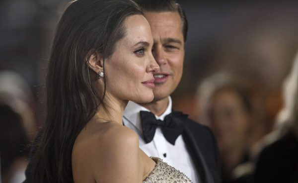 Angelina Jolie and her husband and co-star Brad Pitt pose at the premiere of "By the Sea"