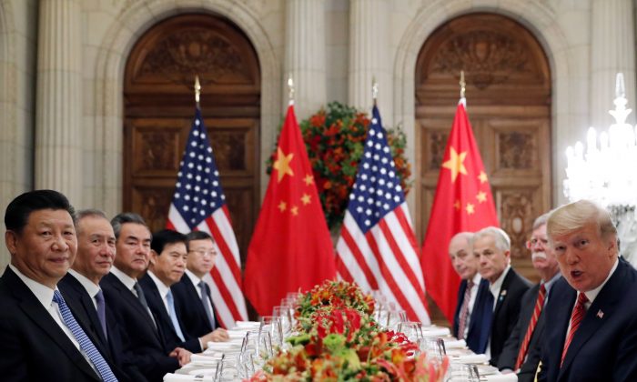U.S. President Donald Trump, President Trump's national security adviser John Bolton, President Trump's trade and manufacturing policy adviser Peter Navarro and others, as well as Chinese President Xi Jinping's leadership team attend a working dinner after the G20 leaders summit in Buenos Aires, Argentina, on Dec. 1, 2018. (Kevin Lamarque/Reuters)