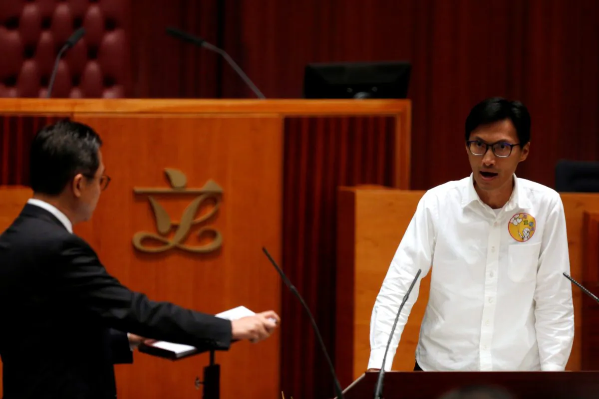 Newly elected lawmaker Eddie Chu shouts slogans while taking oath at the Legislative Council in Hong Kong on Oct. 12, 2016. (Bobby Yip/Reuters)