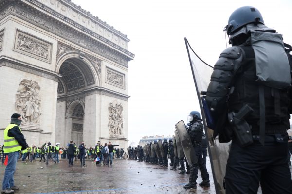 Police officers line up in front of Yellow vest protestors in Place de l'Etoile in Paris on Dec. 1, 2018. (David Vives/The Epoch Times)