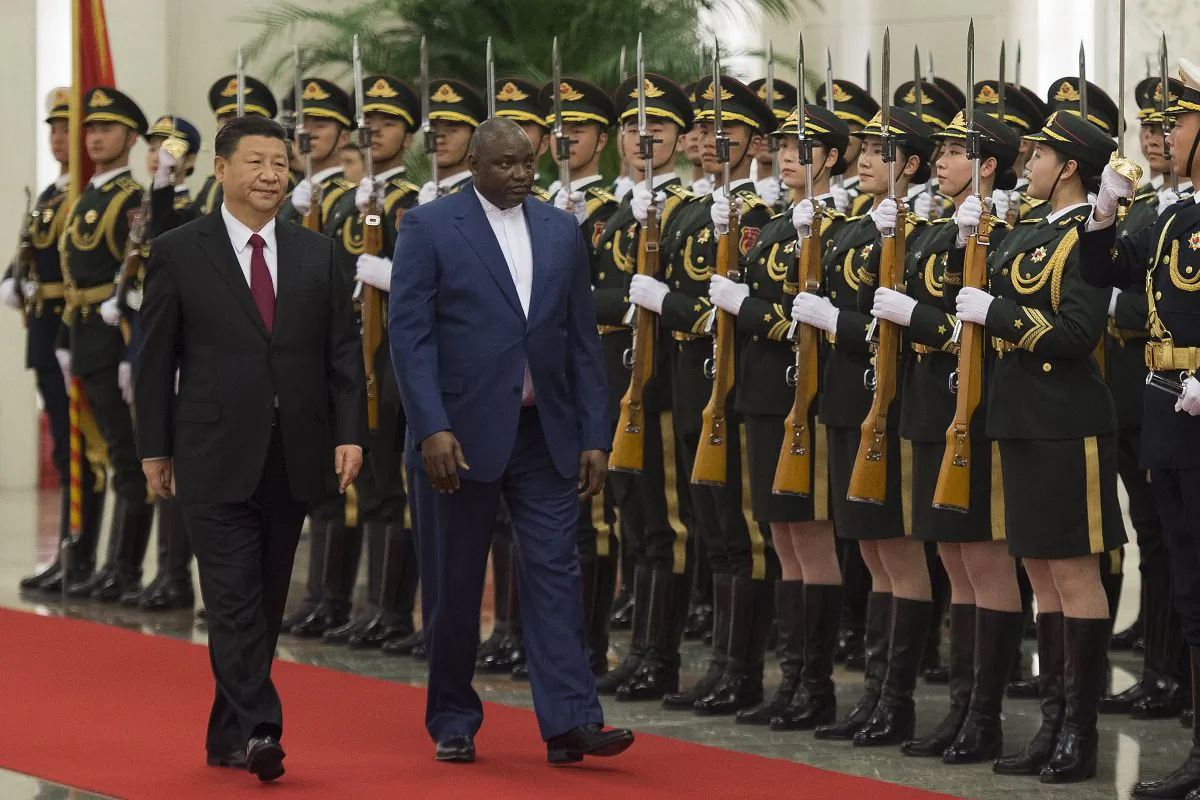 Gambia's President Adama Barrow (C) walks with Chinese leader Xi Jinping (L) during a welcoming ceremony at the Great Hall of the People in Beijing on December 21, 2017.
The two countries re-established diplomatic relations in 2016. (Nicolas Asfouri/AFP/Getty Images)
