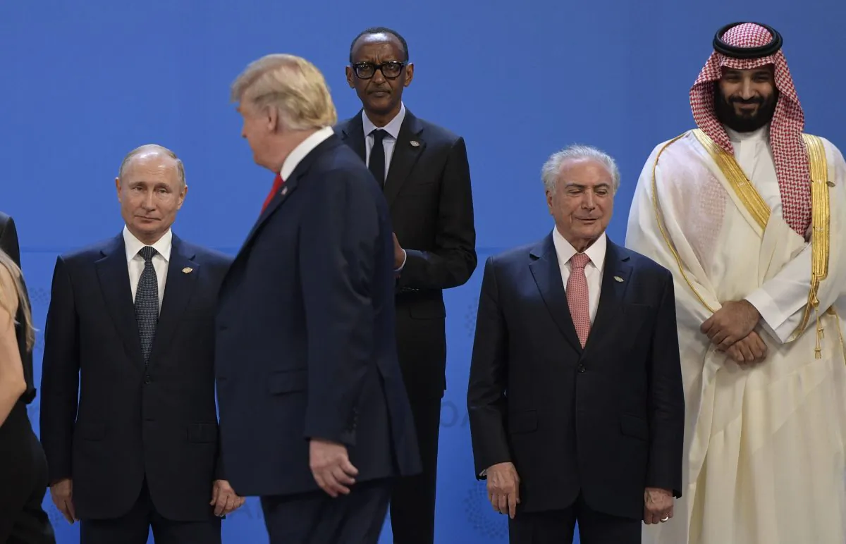 (L to R) Russia's President Vladimir Putin, US President Donald Trump, Rwandas President Paul Kagame, Brazil's President Michel Temer and Saudi Arabia's Crown Prince Mohammed bin Salman line up for a family photo, during the G-20 Leaders' Summit in Buenos Aires, on Nov. 30, 2018. (Juan Mabromate/AFP/Getty Images)