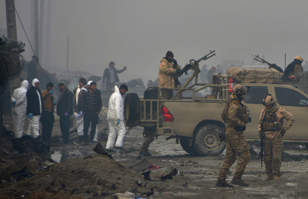 investigators at suicide bomb attack site in Afghanistan