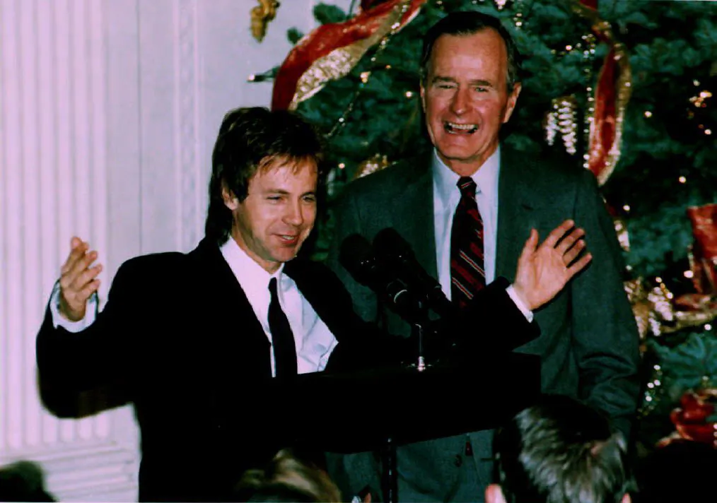 U.S. President George Bush (R) watches as comedian Dana Carvey does his George Bush impersonation on Dec. 7, 1992. Carvey and his wife, Paula, spent the night at the White House as guests of President Bush and First Lady Barbara Bush. (ROBERT GIROUX/AFP/Getty Images)