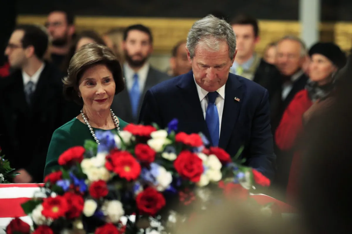 Former President George W. Bush and former First Lady Laura Bush pay their respects to his father former President George H.W. Bush as he lie in state at the U.S. Capitol in Washington, on Dec. 4, 2018. (Manuel Balce Ceneta/AP Photo)