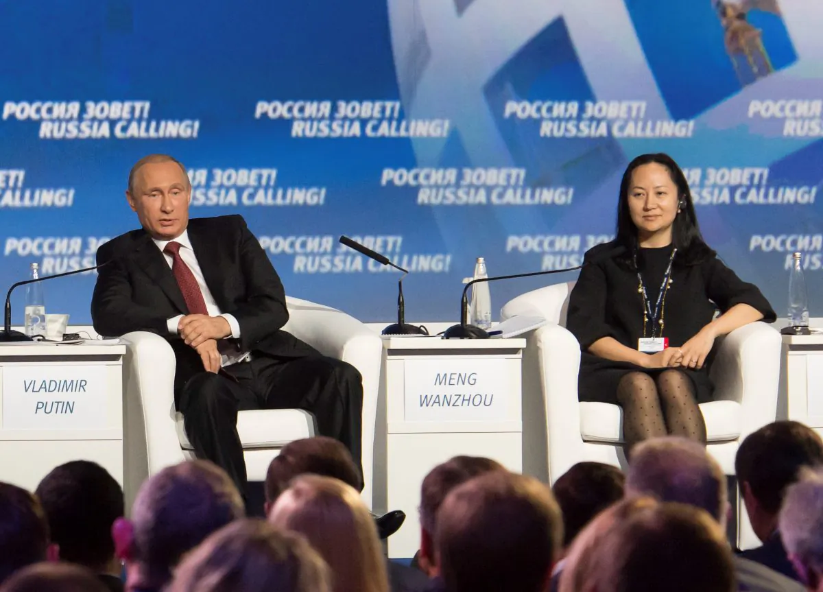 Russia's President Vladimir Putin (L) and Meng Wanzhou, Executive Board Director of the Chinese technology giant Huawei, attend a session of the VTB Capital Investment Forum "Russia Calling!" in Moscow on Oct. 2, 2014. (Alexander Bibik/Reuters)