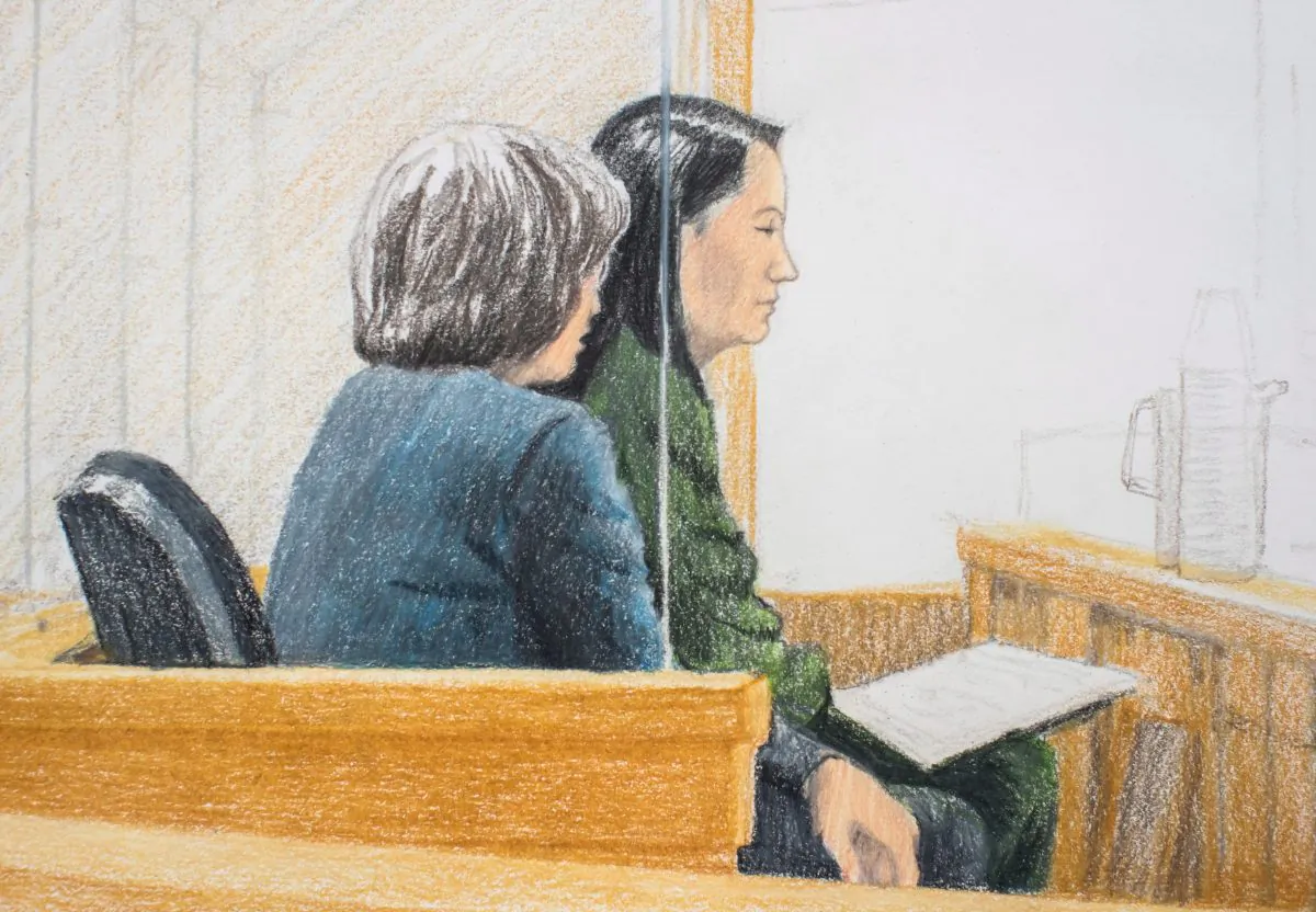 In this courtroom sketch, Meng Wanzhou (L), the chief financial officer of Huawei, sits with a translator during a bail hearing at B.C. Supreme Court in Vancouver, on Dec. 10, 2018. (The Canadian Press/Jane Wolsak)