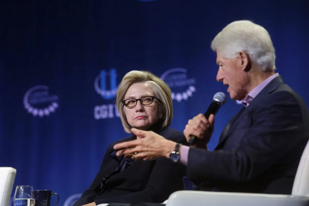 Former Secretary of State Hillary Clinton listens as former President Bill Clinton speaks during the annual Clinton Global Initiative conference at the University of Chicago in Chicago, Ill., on Oct. 16, 2018. (Joshua Lott/Getty Images)