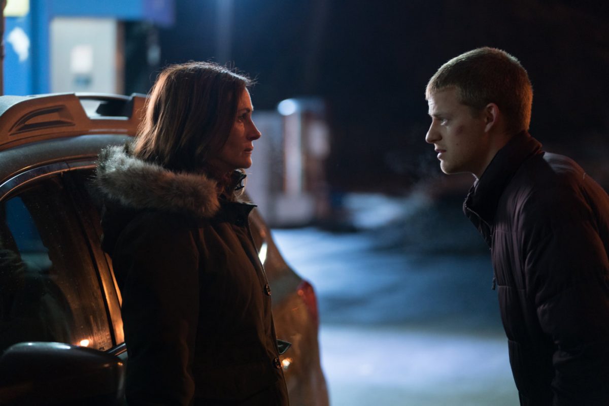 Julia Roberts and Lucas Hedges stand in the cold