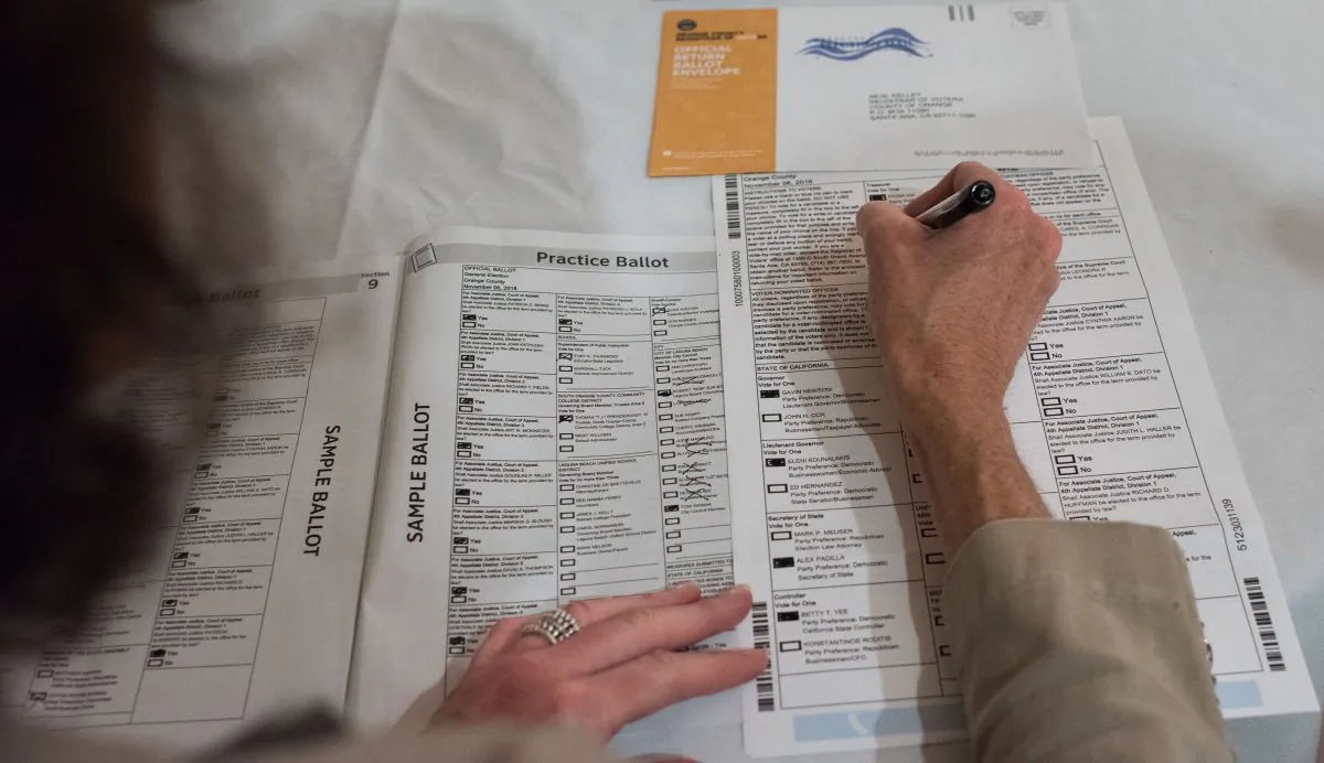 Voter Becky Visconti completes her mail-in ballot at a Ballot Party at a private residence in Laguna Niguel, in Orange County, Calif. on Oct. 24, 2018. (Robyn Beck/AFP/Getty Images)