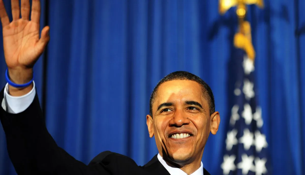 Former U.S. President Barack Obama waves at the audience members during a rally celebrating the passage and signing into law of the Patient Protection and Affordable Care Act health insurance reform bill at the Interior Department in Washington on March 23, 2010.(JEWEL SAMAD/AFP/Getty Images)