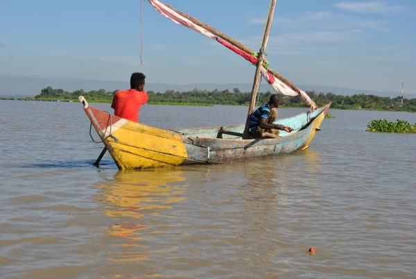 men on the boat trying to catch fish