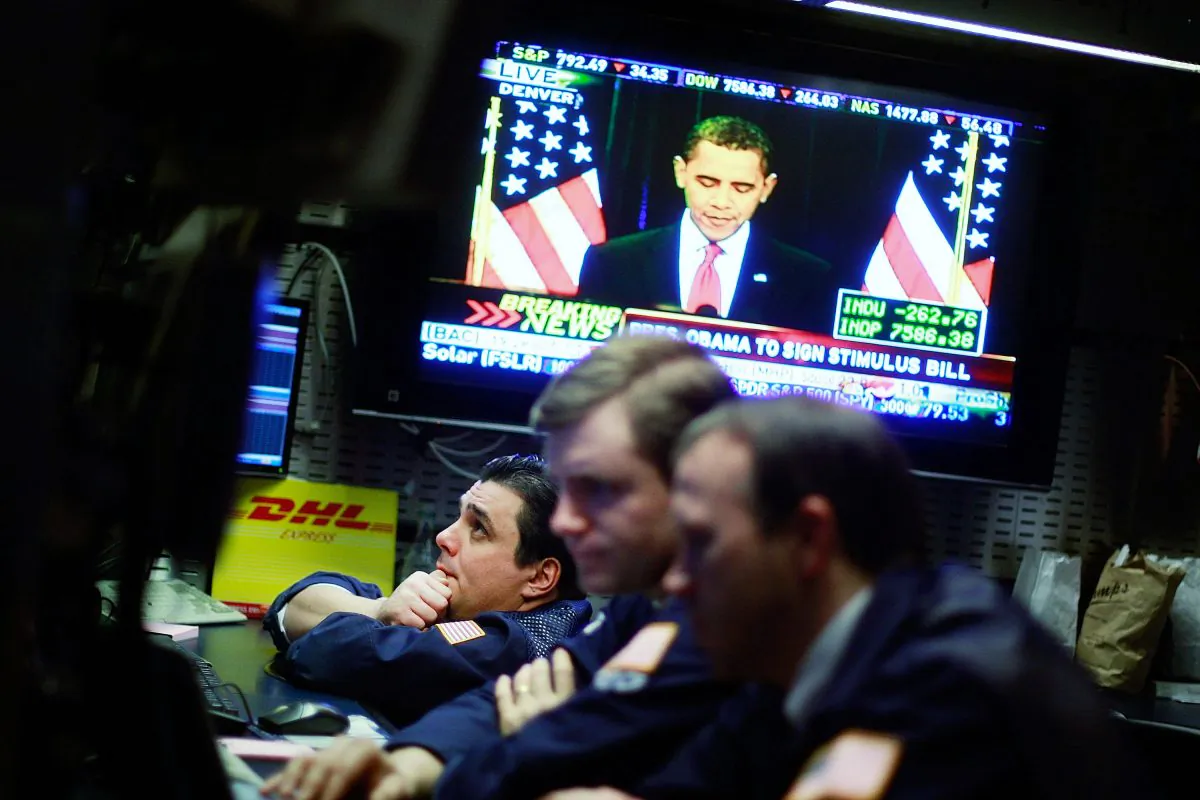 Traders work on the floor of the New York Stock Exchange during afternoon trading as President Barack Obama is seen on television at the economic stimulus bill signing ceremony on Feb. 17, 2009. Despite evidence that stimulus plans do not stimulate the economy, "experts" continue to recommend them. (Mario Tama/Getty Images)