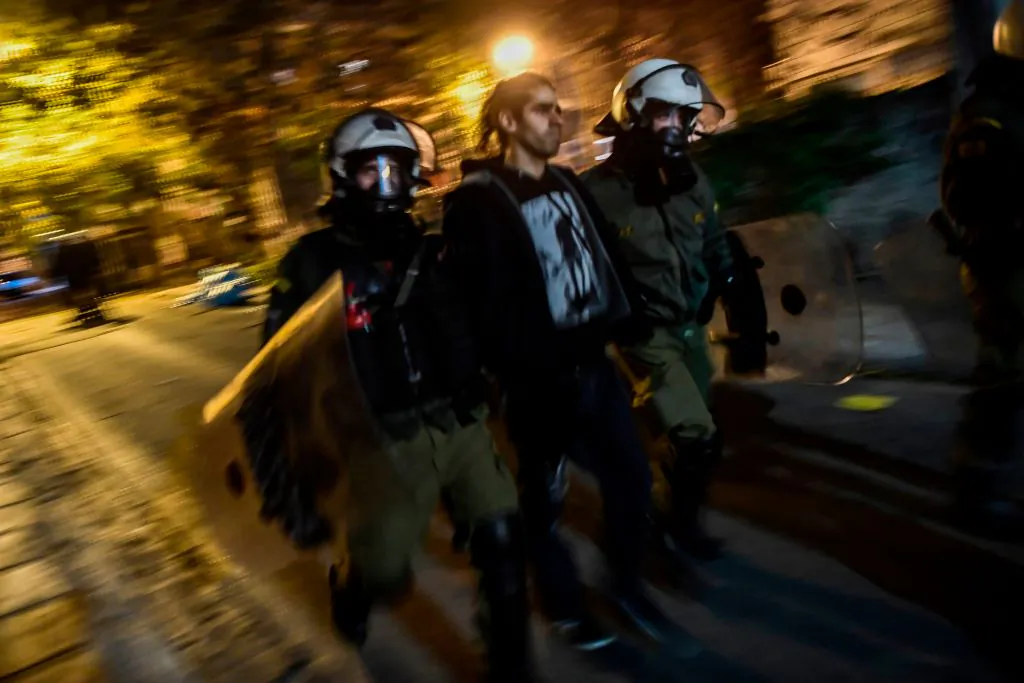 Anti-riot police officers arrest a protester during a demonstration during riots in downtown Athens on Dec. 6, 2018 to commemorate the 10th anniversary of fatal shooting of a teenager which sparked major riots in Greece in 2008.(Aris Messinis/AFP/Getty Images)