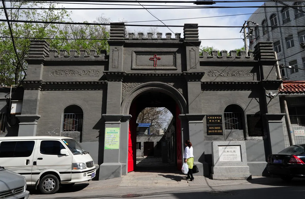 A woman walks to a Christian church in Beijing on April 17, 2011. All religious groups are required to register with the ruling Communist government and worship in officially sanctioned churches. The Beijing Christian Chongwenmen Church, first established in the 1870's by American Methodists and known as Asbury Church, is one of the largest Protestant churches in Beijing. (Frederic J. Brown/AFP/Getty Images)