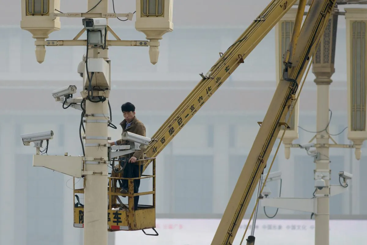 A man checks surveillance cameras on Tiananamen Square in Beijing on Oct. 31, 2013. (Ed Jones/AFP/Getty Images)