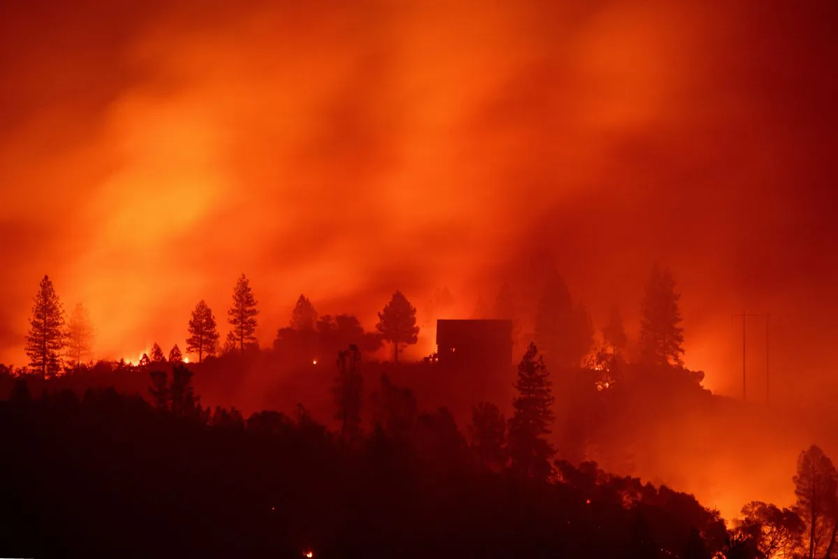 Flames from the Camp fire burn near a home atop a ridge near Big Bend, Calif. on November 10, 2018. (Josh Edelson/AFP/Getty Images)
