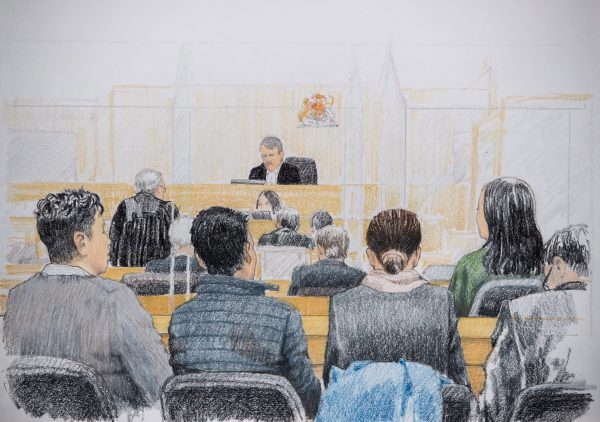 In this courtroom sketch, Meng Wanzhou, back right, the CFO of Huawei Technologies, listens during a bail hearing at B.C. Supreme Court in Vancouver, on Tuesday Dec. 11, 2018. Her husband Liu Xiaozong is seen seated at front left.