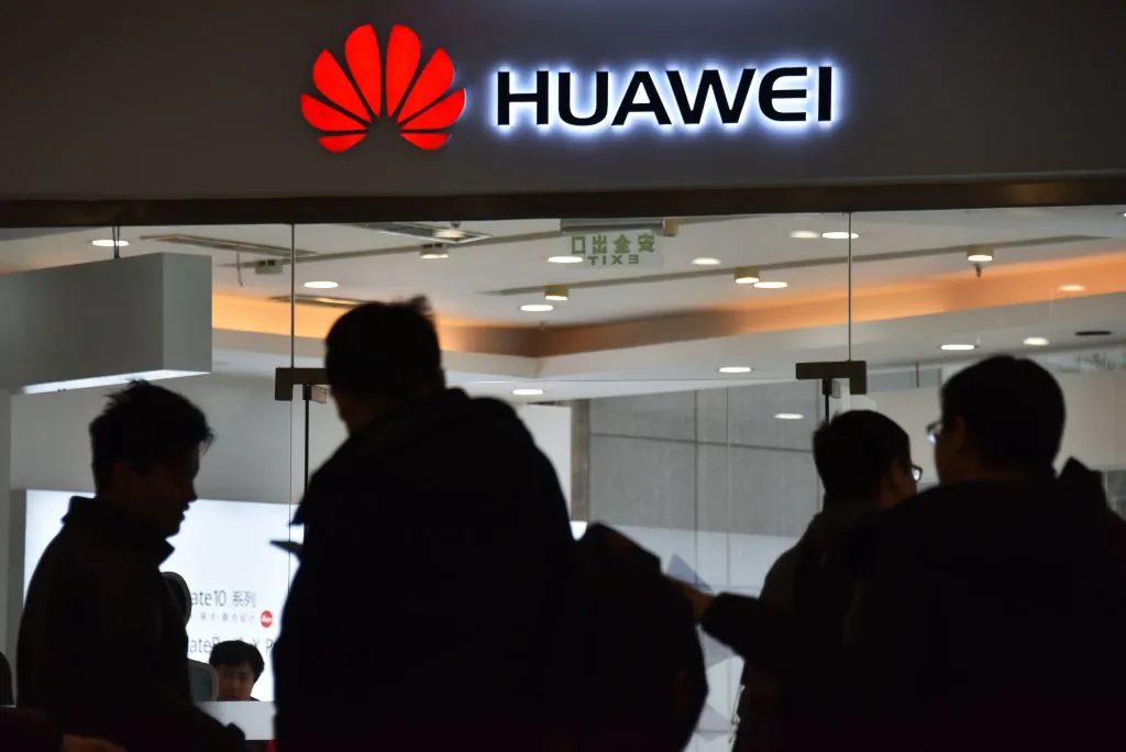 People walk past a Huawei store in Beijing on Dec. 10, 2018. (Greg Baker/AFP/Getty Images)