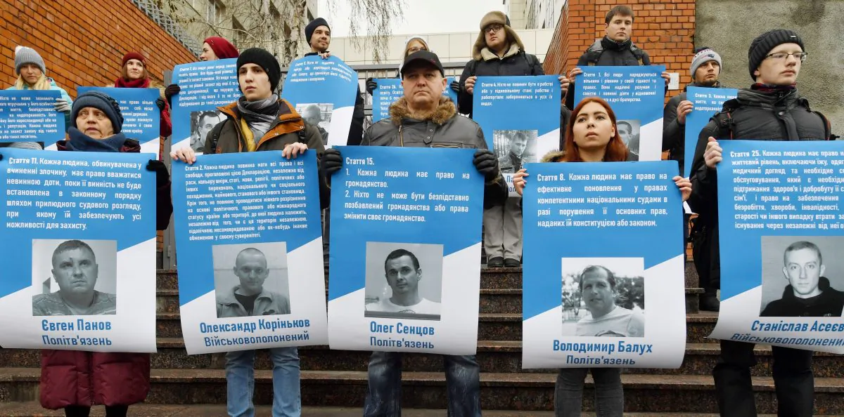 Activists hold pictures of 70 Ukrainian political prisoners jailed in Russia (including the sailors taken in the Azov Sea conflict) during a rally in front of the EU Embassy in Kiev on Dec. 11, 2018. (SERGEI SUPINSKY/AFP/Getty Images)