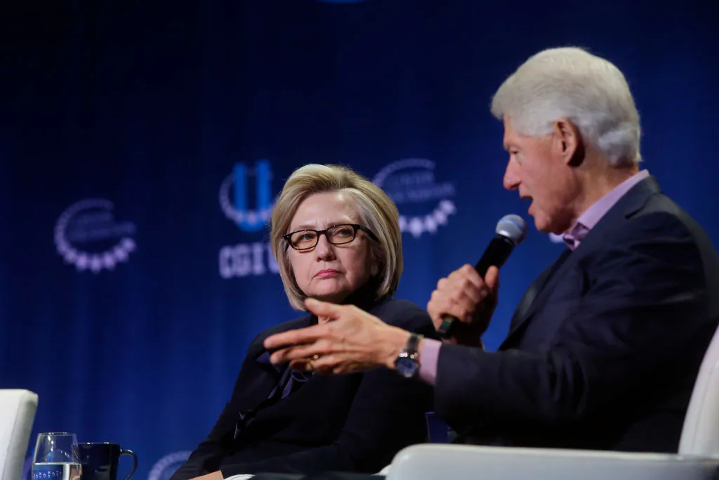 Former Secretary of State Hillary Clinton listens as former President Bill Clinton speaks during the annual Clinton Global Initiative conference at the University of Chicago in Chicago, Illinois, on Oct. 16, 2018. (Photo by Joshua Lott/Getty Images)