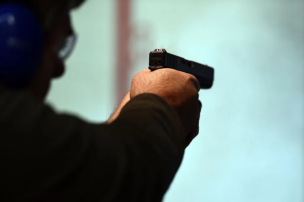 A retired police officer fires a gun at the Ultimate Defense Firing Range and Training Center in St Peters, Missouri, in a Nov. 26, 2014. (Jewel Samad/AFP/Getty Images)