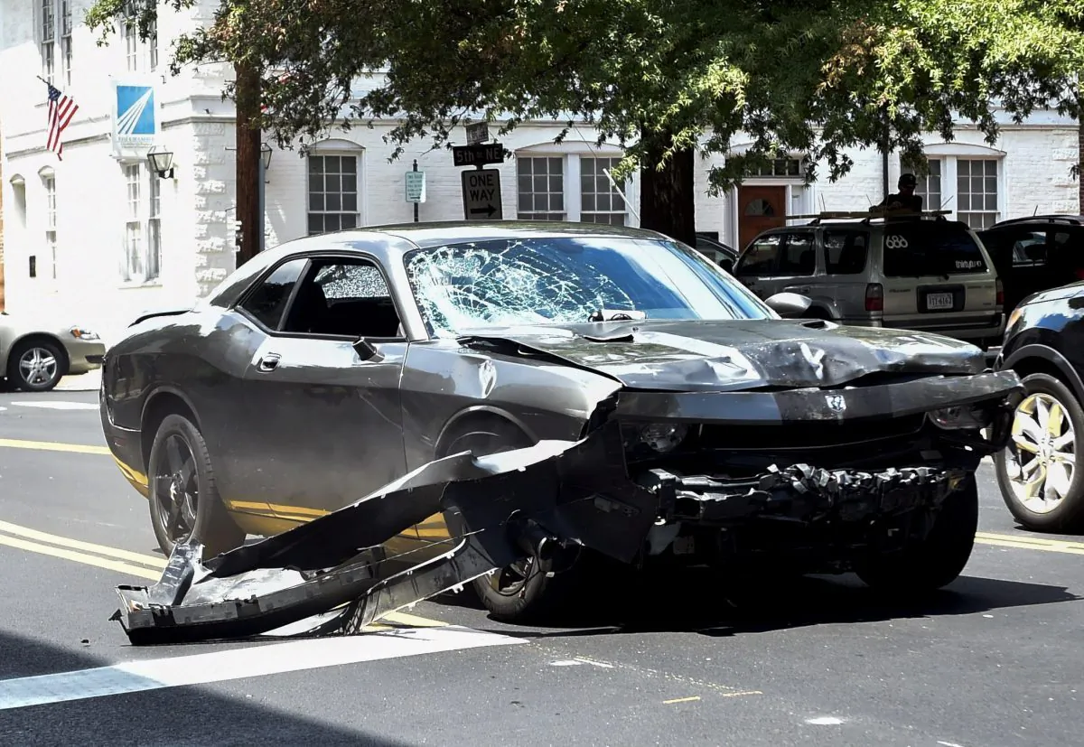 The silver Dodge Charger driven by James Alex Fields Jr. passes near the Market Street Parking Garage moments after driving into a crowd of counter-protesters on Water Street in Charlottesville, Va., on Aug. 12, 2017. Heather Heyer, 32 years old, was killed and 19 others injured when they were struck by Fields’ car. (Matthew Hatcher/Getty Images)