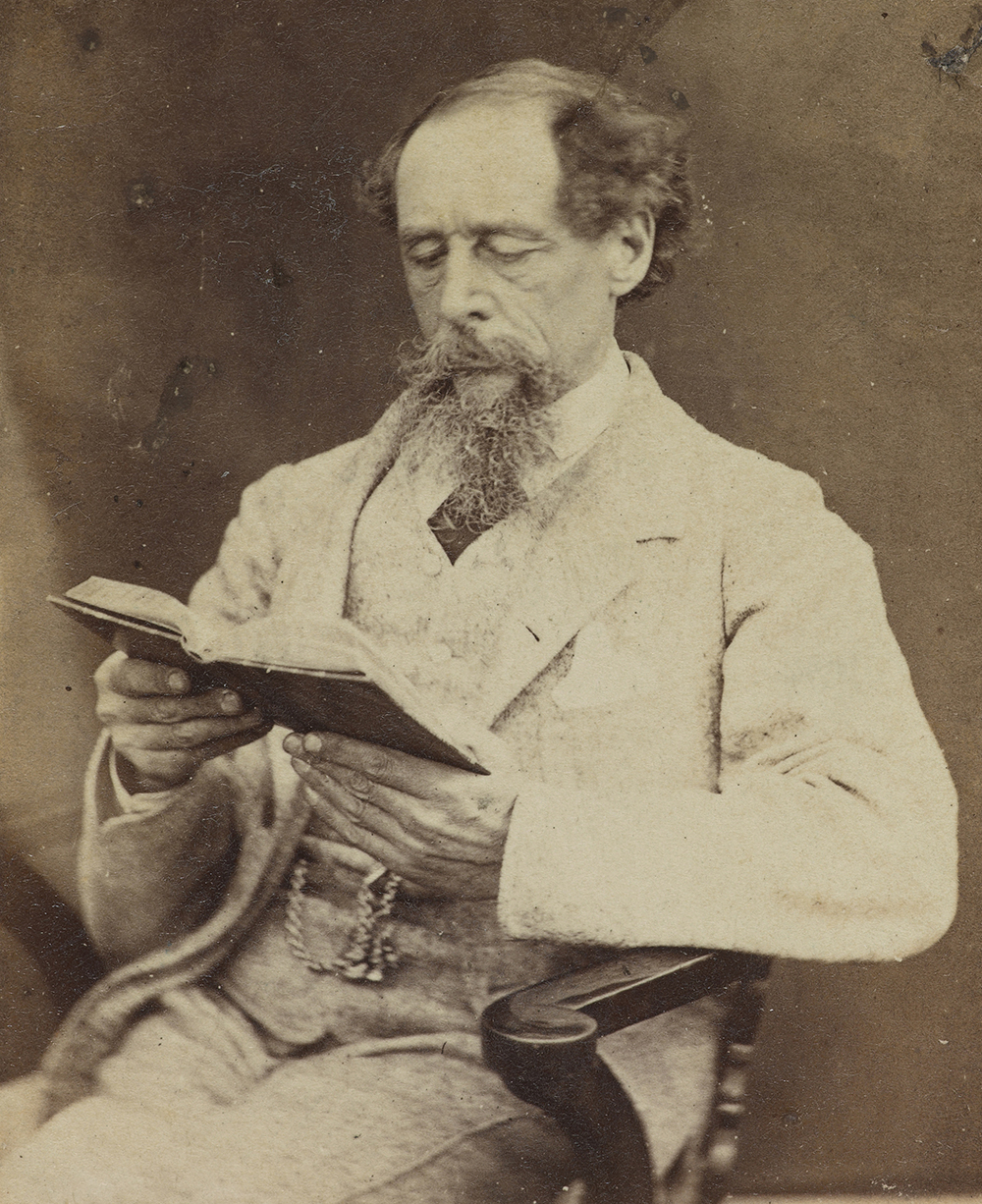 Charles Dickens reading a book