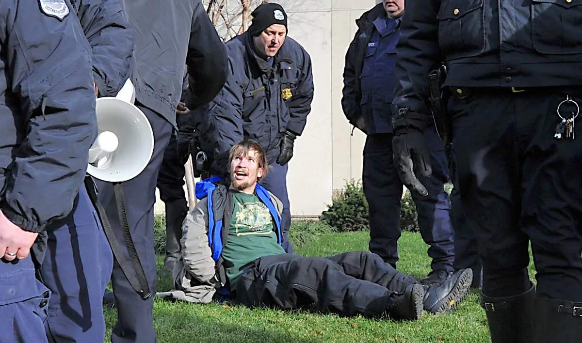 An arrested protester sits on the ground in Washington, on Jan. 19, 2012. (Karen Bleier/AFP/Getty Images)