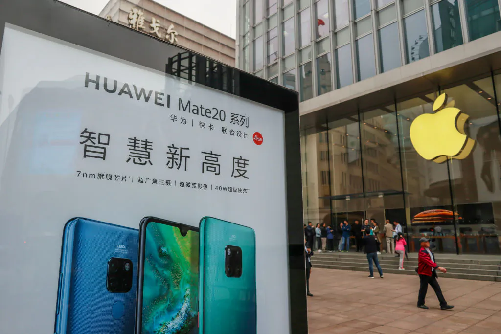 A Huawei poster is displayed outside an Apple store in Shanghai on Oct. 26, 2018. (STR/AFP/Getty Images)