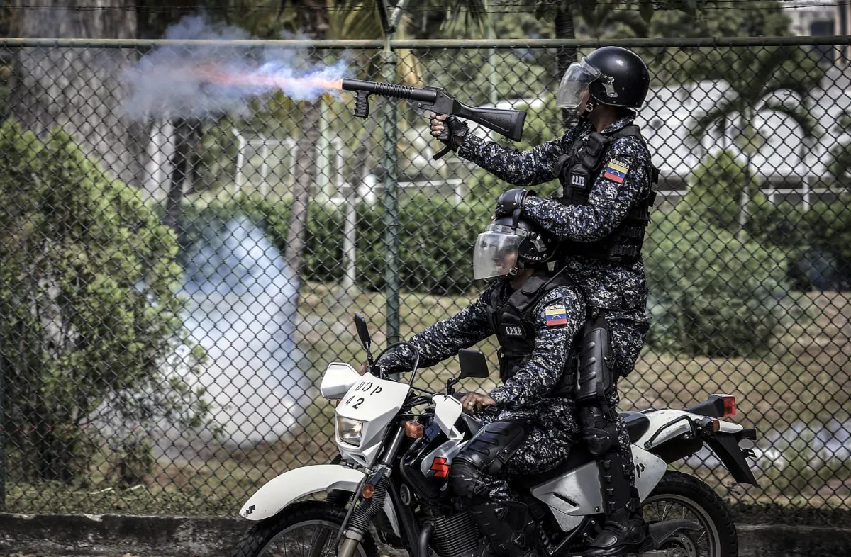 Venezuelan riot policemen shoot tear gas at students in Caracas on Nov. 21, 2018. Chinese technology companies are helping China's communist party to export surveillance tactics to the Maduro regime. (YURI CORTEZ/AFP/Getty Images)