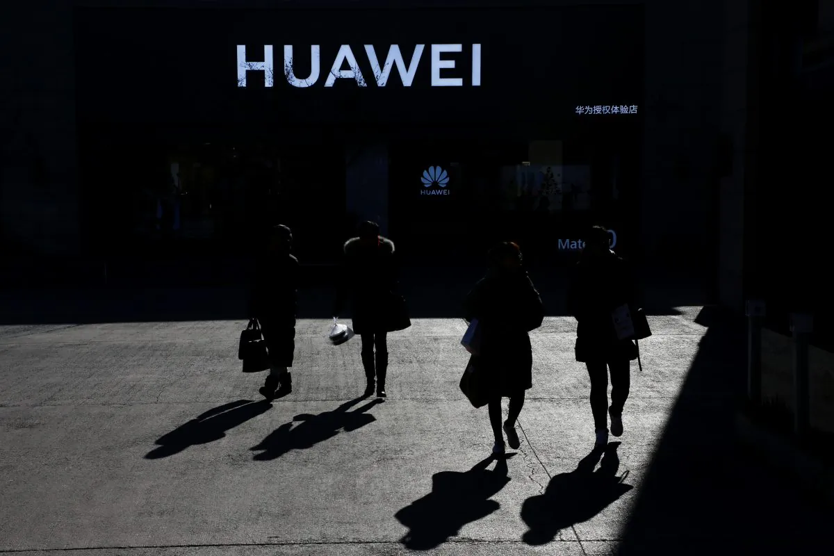 People walk past a Huawei shop in Beijing on Dec. 11, 2018. (Thomas Peter/Reuters)