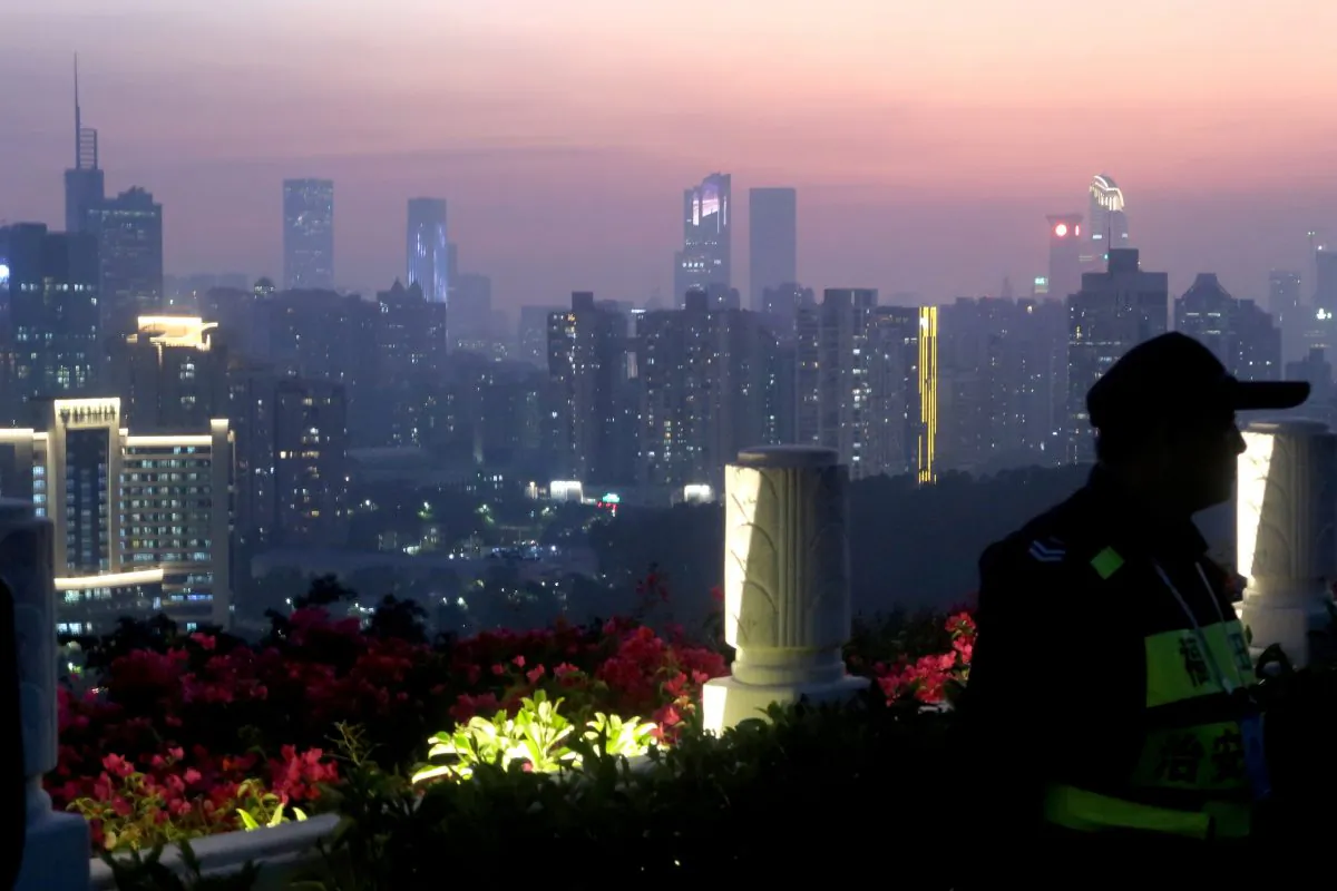 A security personnel stands guard at a viewing platform overlooking the central business area ahead of the 40th anniversary of China's reform and opening up in Shenzhen, Guangdong Province, China on Dec. 4, 2018. (Thomas Suen/Reuters)