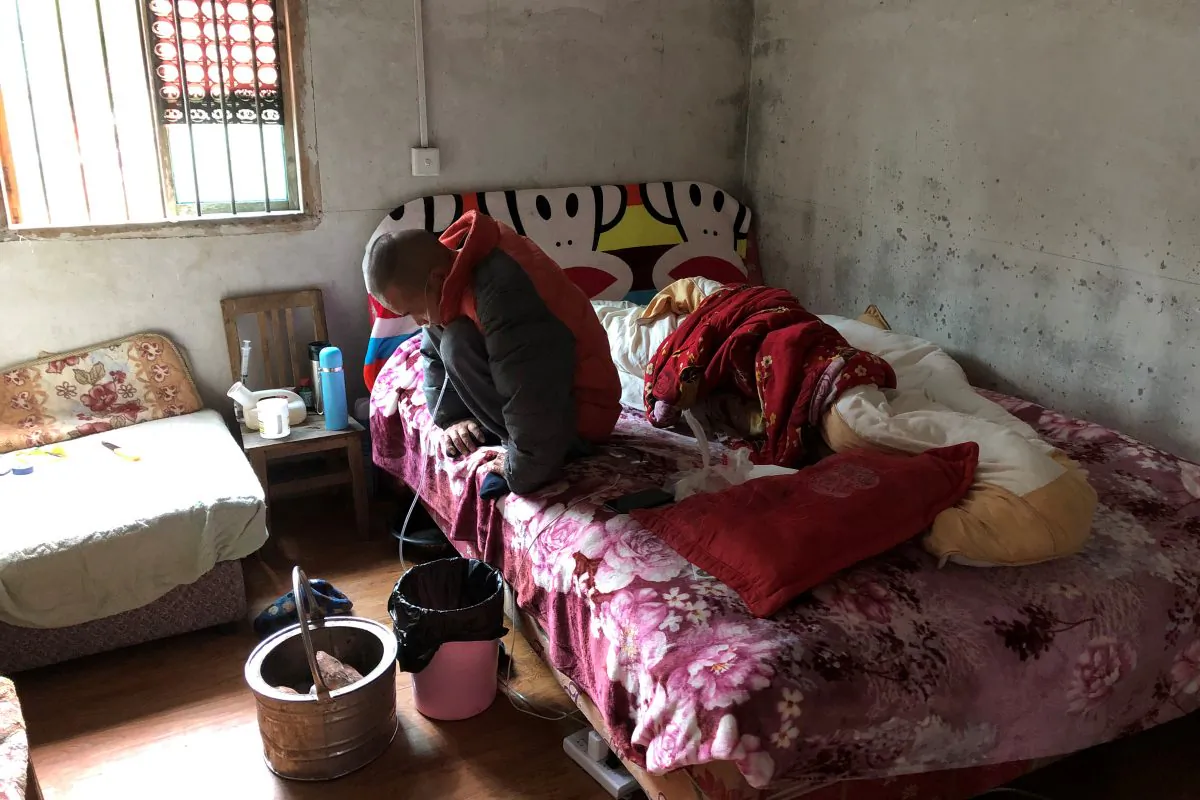 Wang Zhaohong, who suffers from silicosis, is seen on his bed in Sangzhi County, Hunan Province, China on Nov. 27, 2018. (Sue-Lin Wong/Reuters)