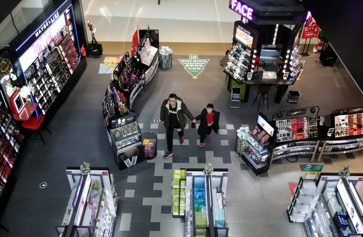 A man and a boy walk at a shopping center in Beijing on Dec. 14, 2018. (Jason Lee/Reuters)