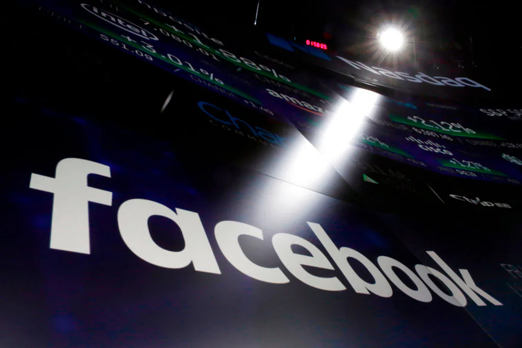 The logo for Facebook appears on screens at the Nasdaq MarketSite in New York's Times Square on March 29, 2018. (AP Photo/Richard Drew, File)