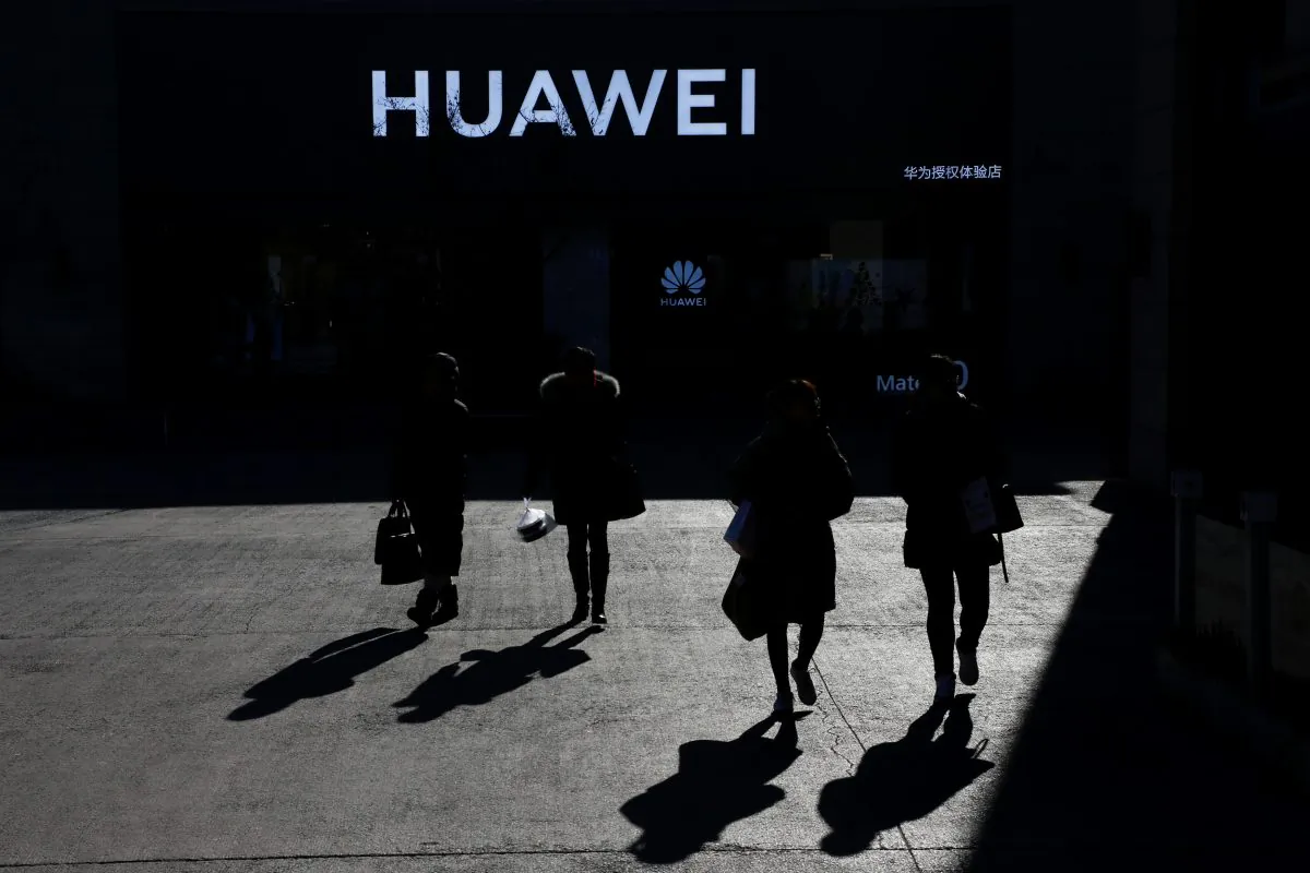 People walk past a Huawei shop in Beijing on Dec. 11, 2018. (Thomas Peter/Reuters)