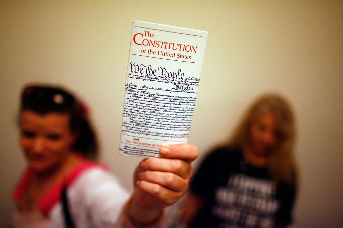 Lisa Petry holds up a copy of the U.S. Constitution on Capitol Hill in Washington on July 25, 2008. (Chip Somodevilla/Getty Images)