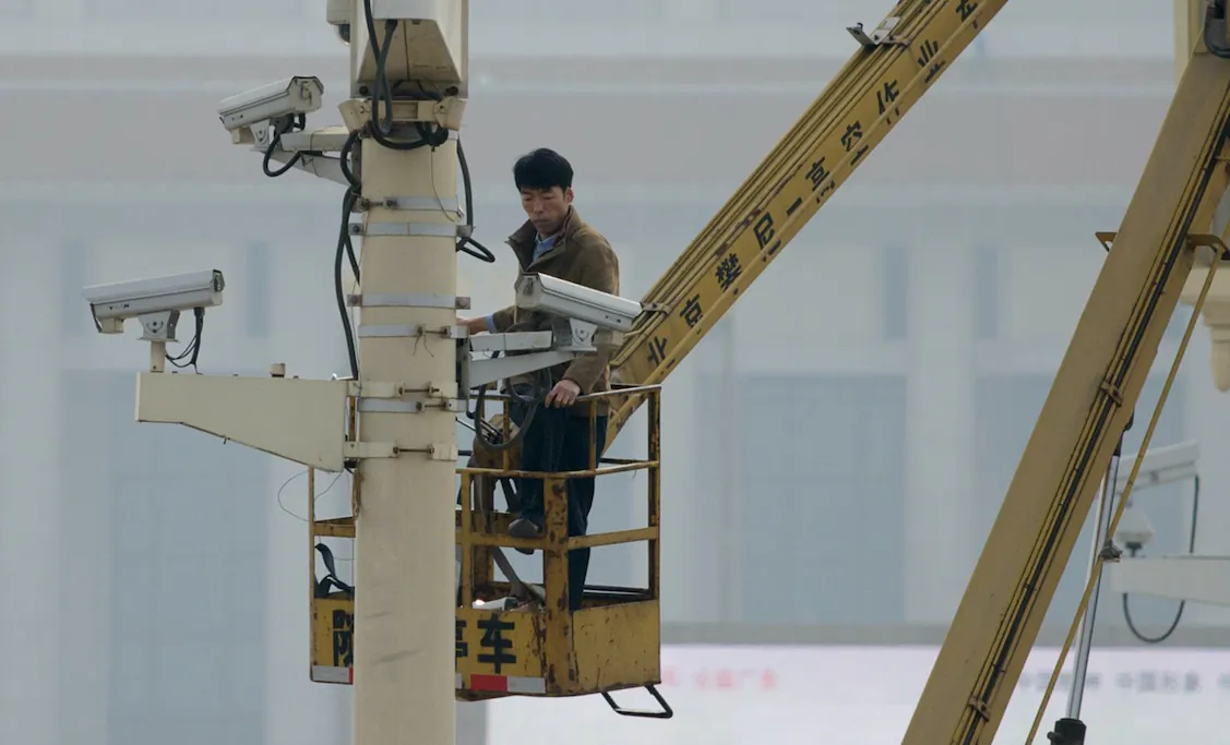 File photo showing a man checking security cameras at Tiananmen Square in Beijing, China, on Oct. 31, 2013. (Ed Jones/Getty Images/AFP)