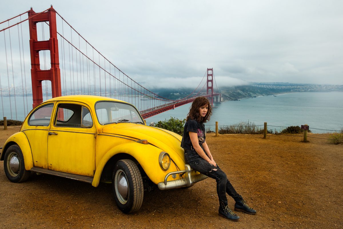 Charlie sits on yellow vw bug